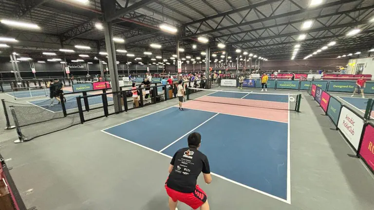 Players using the indoor courts at Ancubic PickleClub.