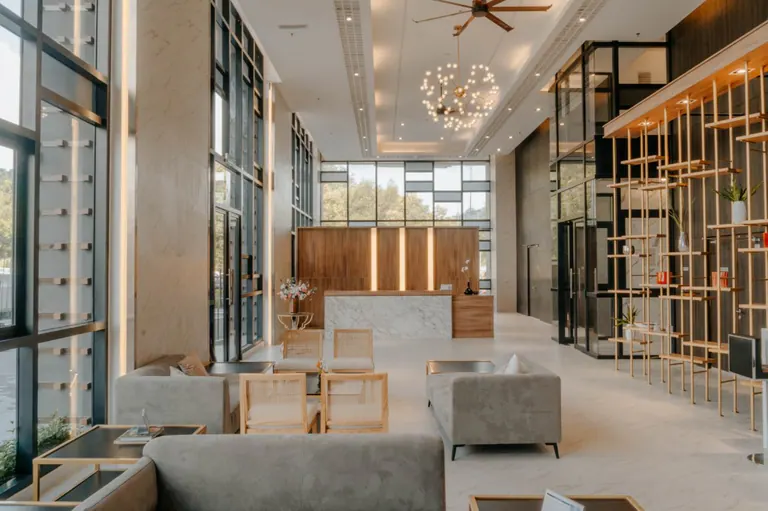 Cubic Botanical lobby with tall windows, timber finishes and carefully detailed interior fittings.